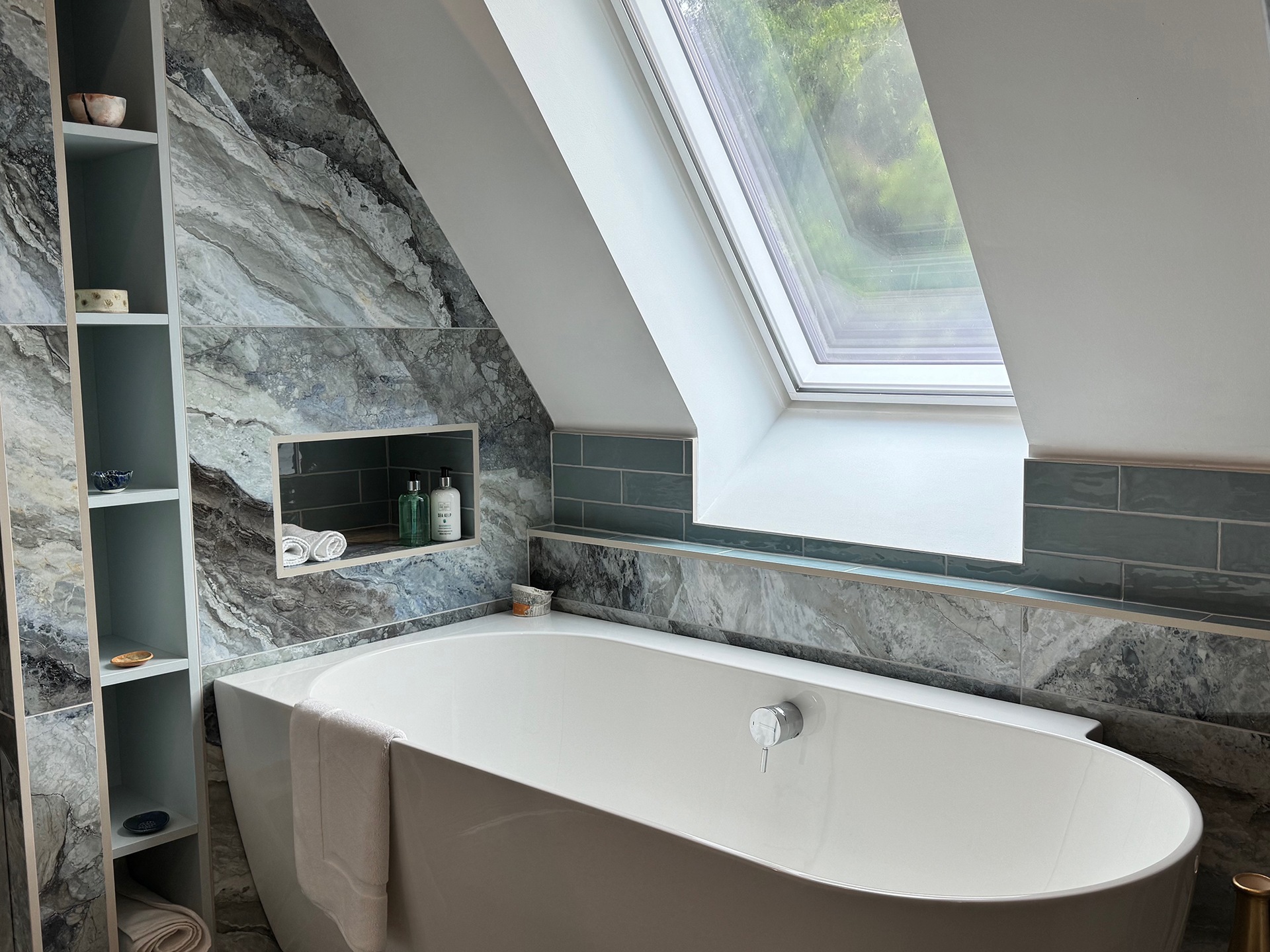 The master bathroom at Warksburn Old church with a tub below a skylight