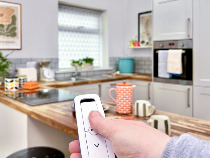 Someone operating blinds using a remote control