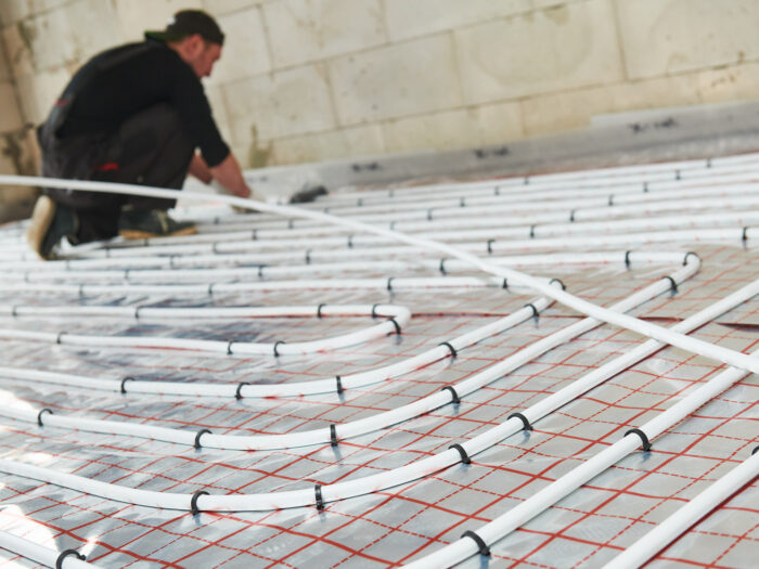Workman laying underfloor heating