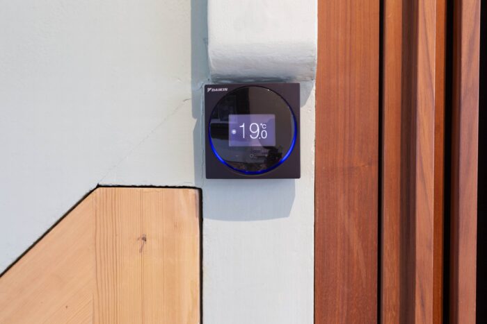 A small control panel on the wall, displaying the temperature