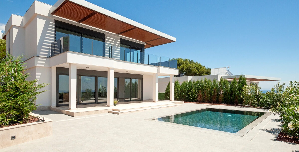 The modern facade of a luxury villa with a large swimming pool. Luxury MODERN property.