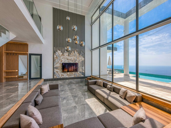 A contemporary home with a large window overlooking the sea
