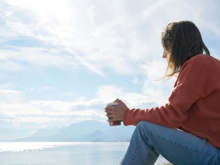 Woman sitting looking thoughtful