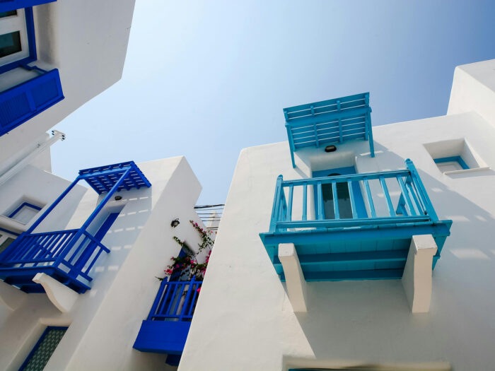 White flat roofed houses with blue balconies