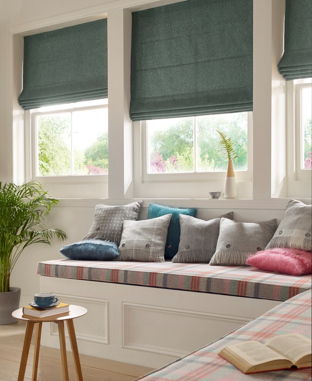 Window seat in corner with cushions and panelled front