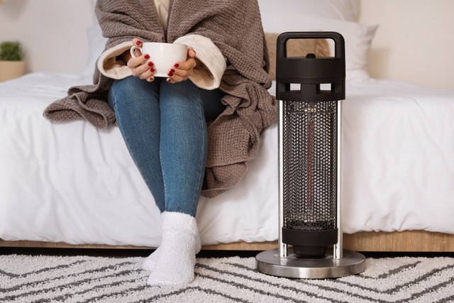 electric heater woman with cuppa
