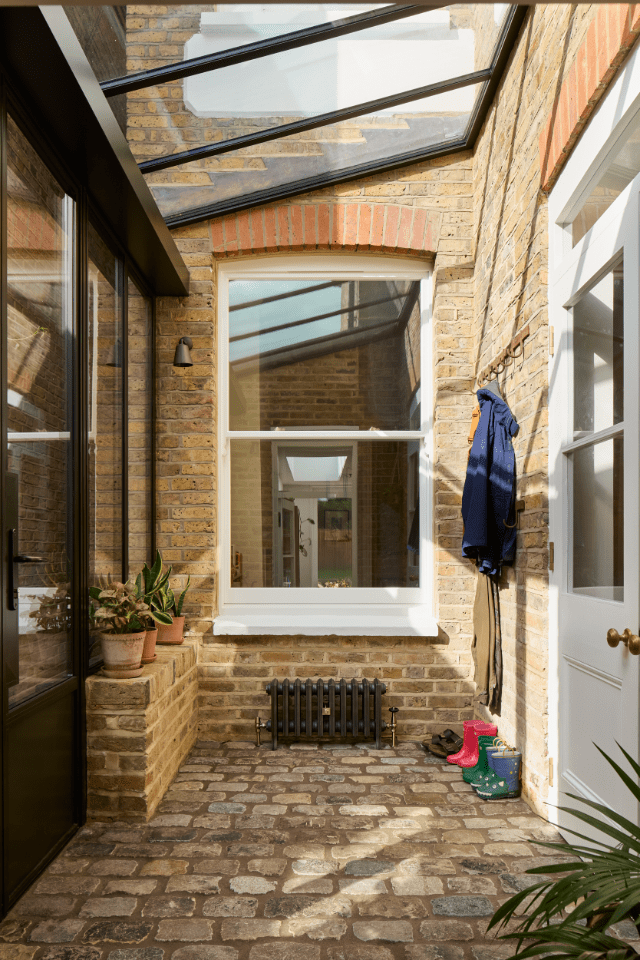 Glazed boot room providing a threshold between inside and outside spaces of Victorian property