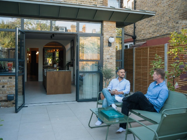 Owners relaxing in outside space of Tooting house extension