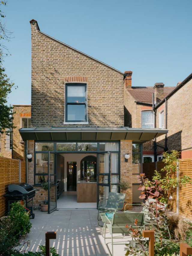 Outside of Tooting house extension with bifold doors and zinc canopy