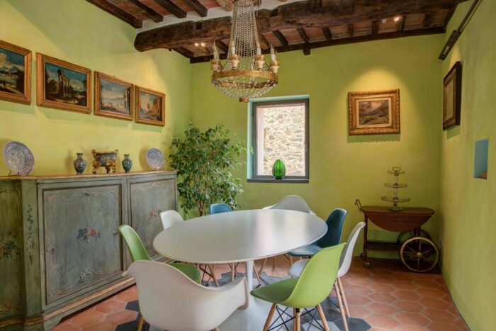 Dining room featuring colourful walls, traditional beams and contemporary furniture