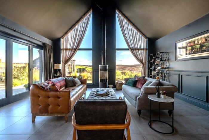interior views out to garden, with vaulted ceiling and full height glazing.