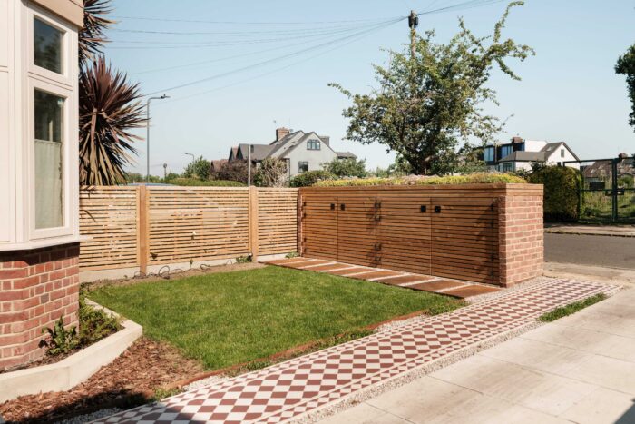 A concealed bike and bin store in the front wall